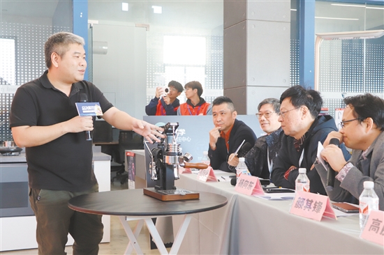大賽評(píng)委與答辯企業(yè)代表交流產(chǎn)品設(shè)計(jì)理念。