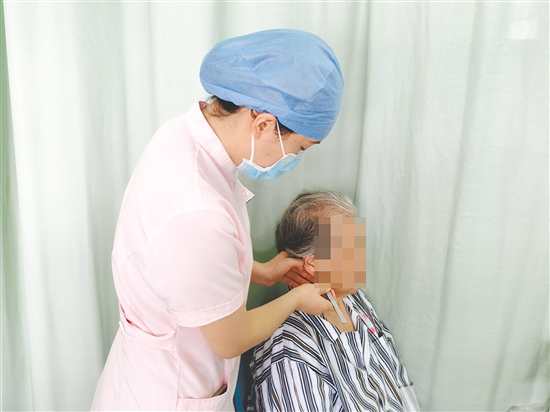 醫(yī)護(hù)人員為患者進(jìn)行中醫(yī)外治療法。