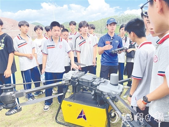 九年級(jí)學(xué)生向飛手了解無人機(jī)的操控技巧。