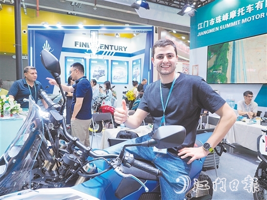 在江門市珠峰摩托車有限公司展位，外國客商前來了解摩托車新品情況，并為產(chǎn)品點(diǎn)贊。張澤彬