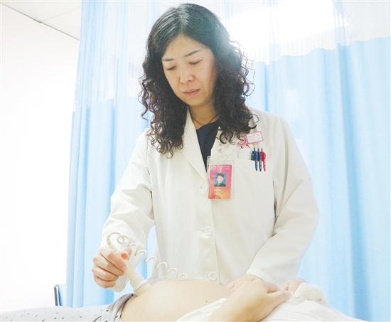 產(chǎn)科醫(yī)生為孕婦檢查胎兒狀況。